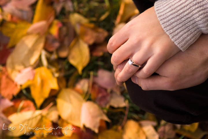 Engaged couple showing their engagement ring. Pre-wedding engagement photo session at Washington College and Chestertown, Maryland, by wedding photographer Leo Dj Photography.