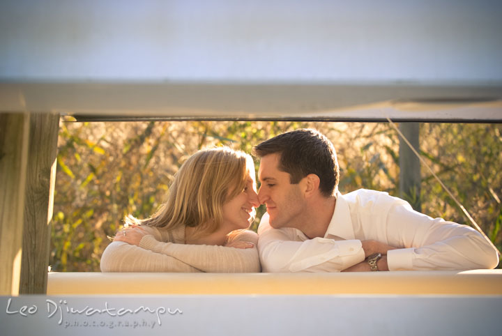 Engaged girl rubbing her nose against her fiance. Pre-wedding engagement photo session at Washington College and Chestertown, Maryland, by wedding photographer Leo Dj Photography.