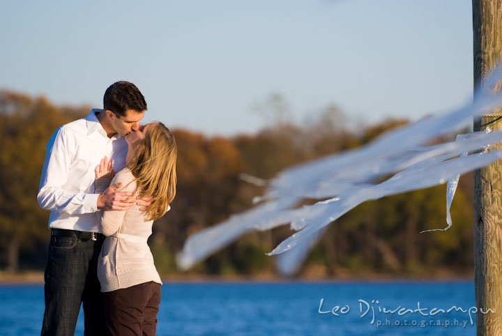 Engaged guy kissing his fiancee. Pre-wedding engagement photo session at Washington College and Chestertown, Maryland, by wedding photographer Leo Dj Photography.