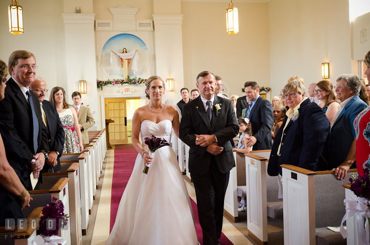 Bride escorted by Father of the Bride walking down the isle for the procession ceremony. St Andrews United Methodist wedding photos at Annapolis, Eastern Shore, Maryland by photographers of Leo Dj Photography.