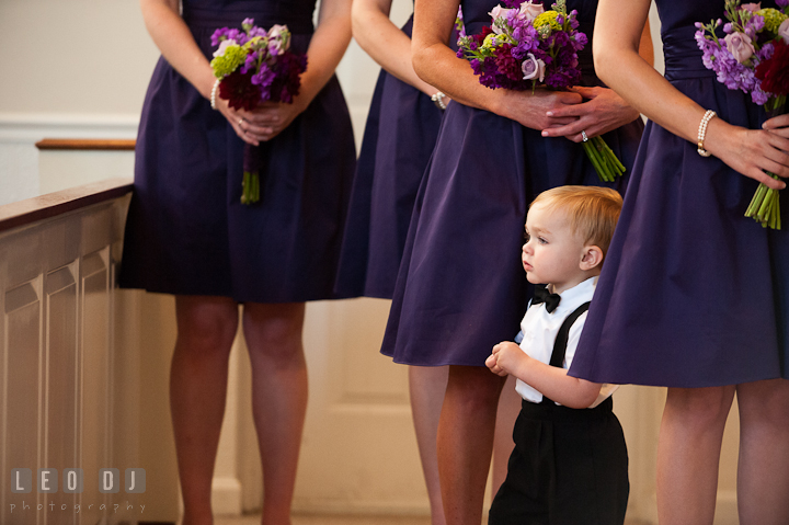 Ring bearer boy amidst the Bridesmaids purple dress. St Andrews United Methodist wedding photos at Annapolis, Eastern Shore, Maryland by photographers of Leo Dj Photography.