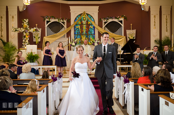 Bride and Groom walking out of the isle at the end of the ceremony. St Andrews United Methodist wedding photos at Annapolis, Eastern Shore, Maryland by photographers of Leo Dj Photography.