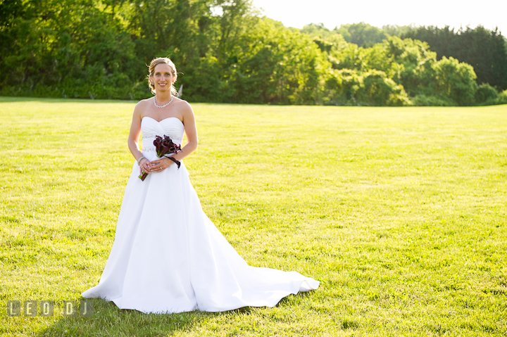 Bride posing showing her wedding dress. St Andrews United Methodist wedding photos at Annapolis, Eastern Shore, Maryland by photographers of Leo Dj Photography.