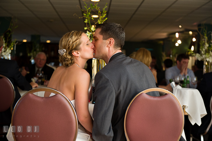 Bride and Groom kissing at the sweetheart table. Yellowfin Restaurant wedding reception photos at Annapolis, Eastern Shore, Maryland by photographers of Leo Dj Photography.