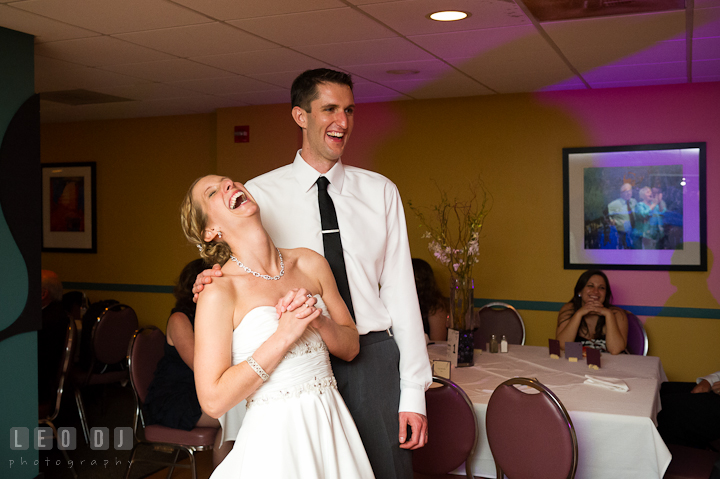 Bride and Groom laughed getting tips from anniversary dance winner. Yellowfin Restaurant wedding reception photos at Annapolis, Eastern Shore, Maryland by photographers of Leo Dj Photography.