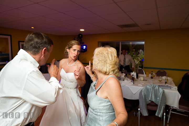 Bride dancing with her parents. Yellowfin Restaurant wedding reception photos at Annapolis, Eastern Shore, Maryland by photographers of Leo Dj Photography.
