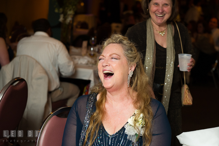 Mother of Groom laughing looking at her sons dance. Yellowfin Restaurant wedding reception photos at Annapolis, Eastern Shore, Maryland by photographers of Leo Dj Photography.