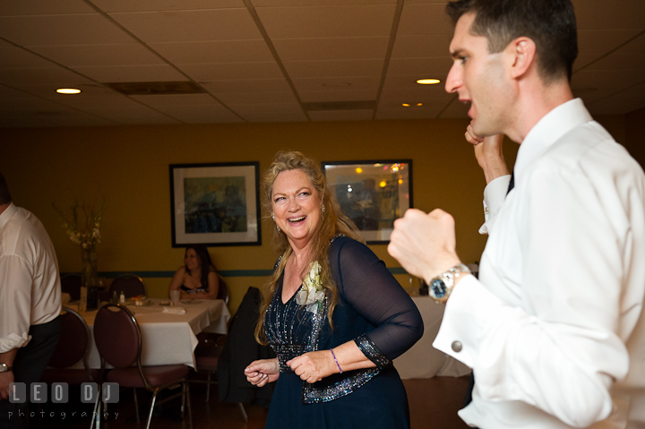 Mother of Groom having fun and dancing with son. Yellowfin Restaurant wedding reception photos at Annapolis, Eastern Shore, Maryland by photographers of Leo Dj Photography.