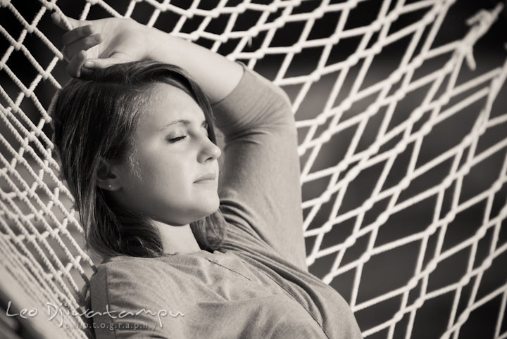 Girl laying on hammock, enjoying the sun. Eastern Shore, Maryland, Kent Island High School senior portrait session by photographer Leo Dj Photography.