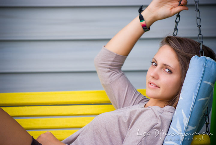 Girl sitting on yellow swing. Eastern Shore, Maryland, Kent Island High School senior portrait session by photographer Leo Dj Photography.