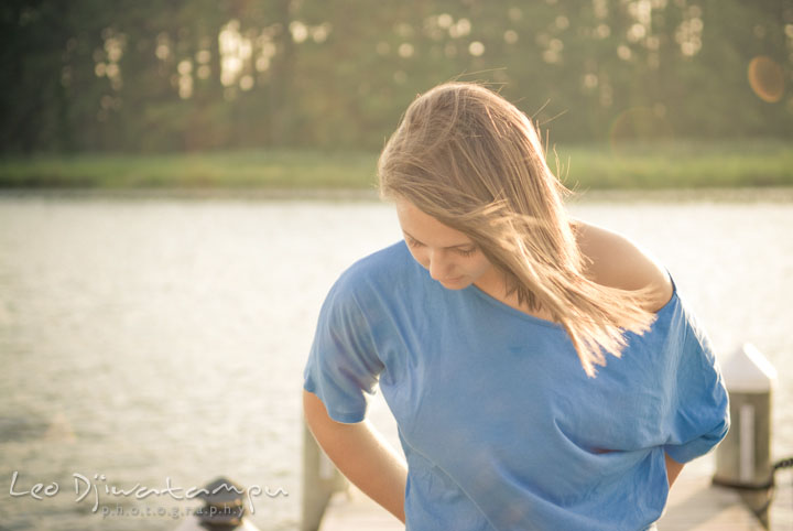 Girl on boat dock, looking down. Eastern Shore, Maryland, Kent Island High School senior portrait session by photographer Leo Dj Photography.