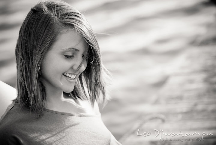 Girl on pier smiling. Eastern Shore, Maryland, Kent Island High School senior portrait session by photographer Leo Dj Photography.