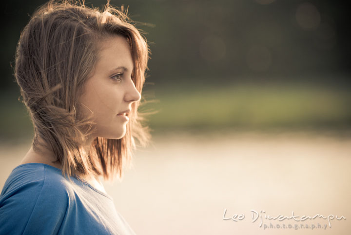 Girl looking at a distance, windblown hair. Eastern Shore, Maryland, Kent Island High School senior portrait session by photographer Leo Dj Photography.