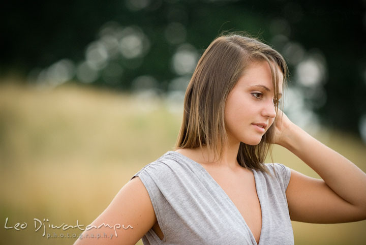 Girl brushing her hair with her fingers. Eastern Shore, Maryland, Kent Island High School senior portrait session by photographer Leo Dj Photography.