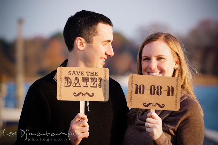 Engaged guy and girl holding their save the date cards. Chestertown Maryland and Washington College Pre-Wedding Engagement Session Photographer, Leo Dj Photography