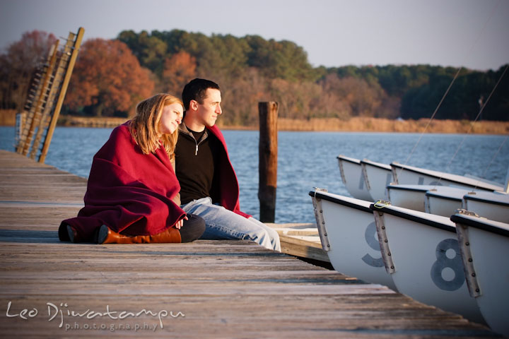 Fiancée leaning on fiancé's shoulder looking at the creek. Chestertown Maryland and Washington College Pre-Wedding Engagement Session Photographer, Leo Dj Photography