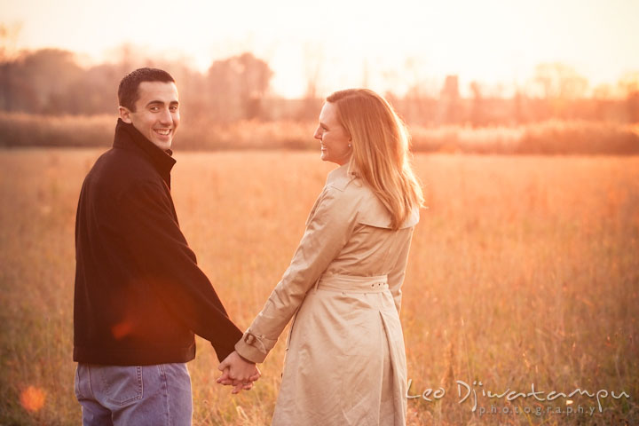 Engaged guy and girl in a meadow holding hands. Chestertown Maryland and Washington College Pre-Wedding Engagement Session Photographer, Leo Dj Photography