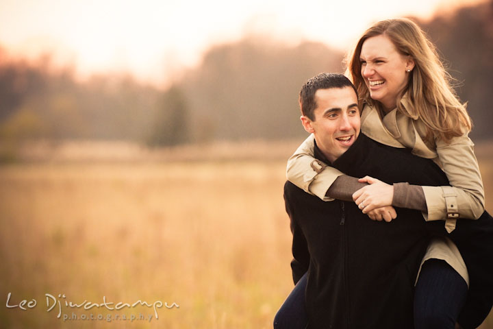 Engaged girl riding on fiancé's back, laughing. Chestertown Maryland and Washington College Pre-Wedding Engagement Session Photographer, Leo Dj Photography