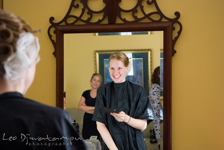 Bride looking at mirror checking out her hair do. The Tidewater Inn Wedding, Easton Maryland, getting ready photo coverage of Kelsey and Jonnie by wedding photographers of Leo Dj Photography.