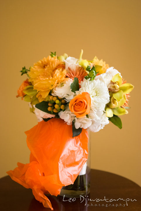 Orange flower bouquet. The Tidewater Inn Wedding, Easton Maryland, getting ready photo coverage of Kelsey and Jonnie by wedding photographers of Leo Dj Photography.