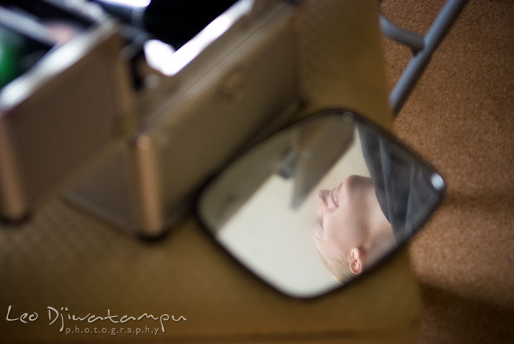 Reflection of bride on small makeup mirror. The Tidewater Inn Wedding, Easton Maryland, getting ready photo coverage of Kelsey and Jonnie by wedding photographers of Leo Dj Photography.