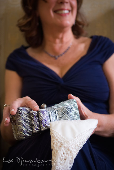 Mother of the bride holding purse and custom embroidered handkerchief. The Tidewater Inn Wedding, Easton Maryland, getting ready photo coverage of Kelsey and Jonnie by wedding photographers of Leo Dj Photography.