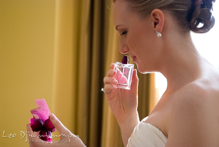 Bride smelling the Lovestruck perfume bottle, by Vera Wang. The Tidewater Inn Wedding, Easton Maryland, getting ready photo coverage of Kelsey and Jonnie by wedding photographers of Leo Dj Photography.