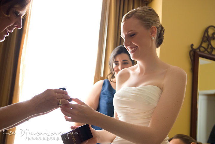 Bride opening gift from groom. The Tidewater Inn Wedding, Easton Maryland, getting ready photo coverage of Kelsey and Jonnie by wedding photographers of Leo Dj Photography.