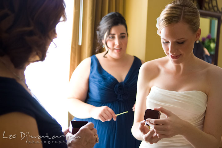 Bride looking at earring gift from groom. The Tidewater Inn Wedding, Easton Maryland, getting ready photo coverage of Kelsey and Jonnie by wedding photographers of Leo Dj Photography.