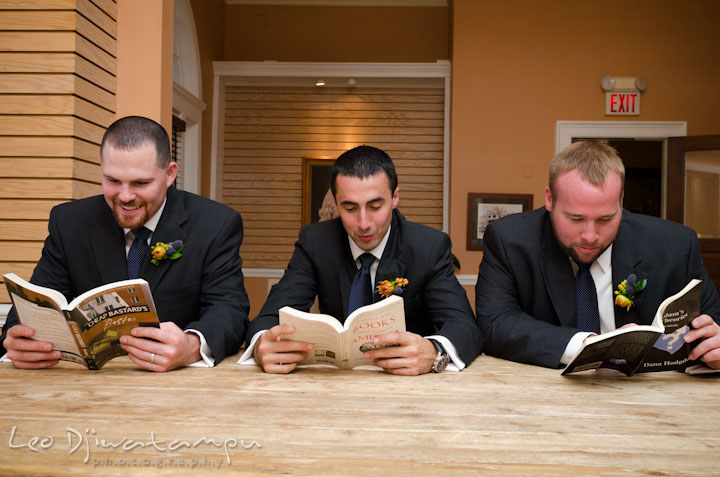 Groom and best men reading books. The Tidewater Inn Wedding, Easton Maryland, getting ready photo coverage of Kelsey and Jonnie by wedding photographers of Leo Dj Photography.