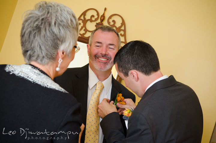 Groom help his father putting on boutonniere. The Tidewater Inn Wedding, Easton Maryland, getting ready photo coverage of Kelsey and Jonnie by wedding photographers of Leo Dj Photography.