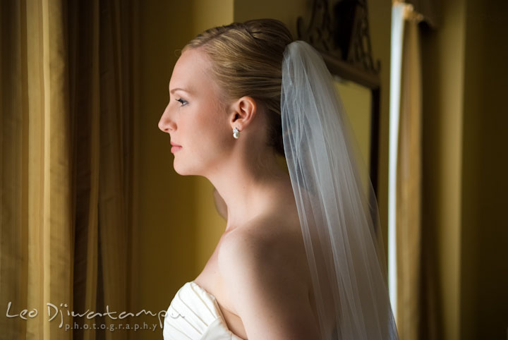 Bride looking out the window. The Tidewater Inn Wedding, Easton Maryland, getting ready photo coverage of Kelsey and Jonnie by wedding photographers of Leo Dj Photography.