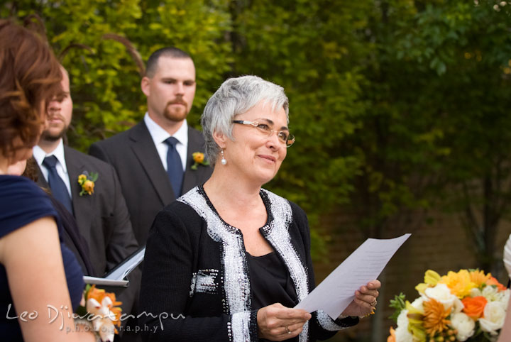 Mother of groom reading letter to bride and groom. The Tidewater Inn Wedding, Easton Maryland, ceremony photo coverage of Kelsey and Jonnie by wedding photographers of Leo Dj Photography.