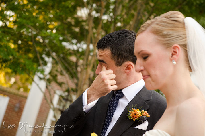 Groom wiping of tears from his eyes. The Tidewater Inn Wedding, Easton Maryland, ceremony photo coverage of Kelsey and Jonnie by wedding photographers of Leo Dj Photography.