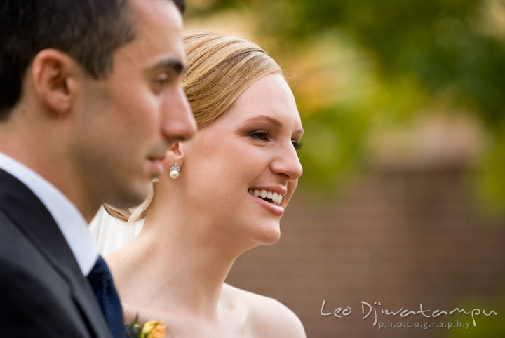 Bride and groom listening to maid of honor reading a passage. The Tidewater Inn Wedding, Easton Maryland, ceremony photo coverage of Kelsey and Jonnie by wedding photographers of Leo Dj Photography.