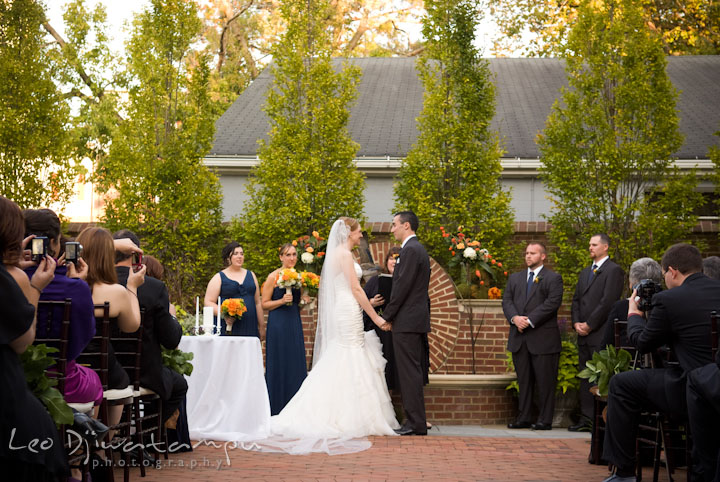 Bride and groom holding hand. The Tidewater Inn Wedding, Easton Maryland, ceremony photo coverage of Kelsey and Jonnie by wedding photographers of Leo Dj Photography.