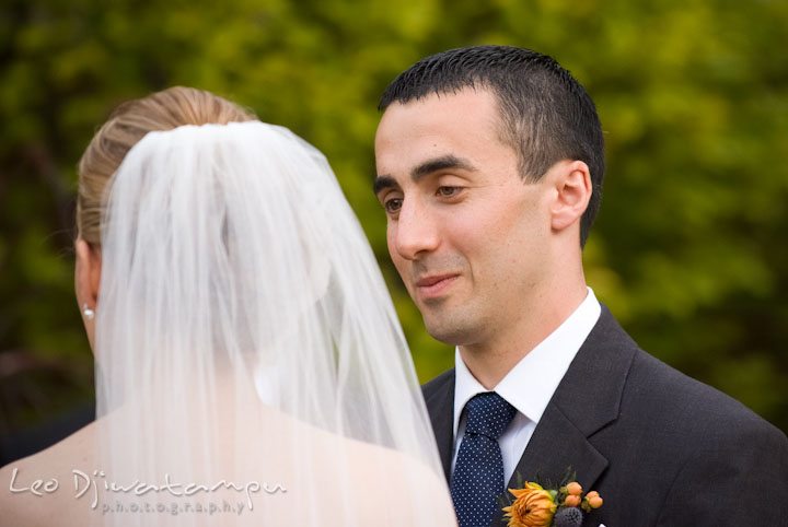 Groom looking at bride with lots of love while reciting vow. The Tidewater Inn Wedding, Easton Maryland, ceremony photo coverage of Kelsey and Jonnie by wedding photographers of Leo Dj Photography.