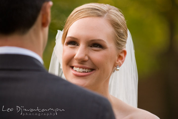 Bride smile at groom while reciting wedding vow. The Tidewater Inn Wedding, Easton Maryland, ceremony photo coverage of Kelsey and Jonnie by wedding photographers of Leo Dj Photography.