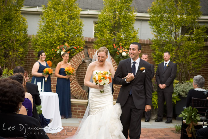 Bride and groom walking out. The Tidewater Inn Wedding, Easton Maryland, ceremony photo coverage of Kelsey and Jonnie by wedding photographers of Leo Dj Photography.