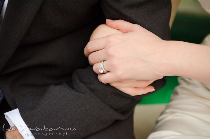 Bride's hand holding groom's arm and showing engagement ring and wedding band. The Tidewater Inn Wedding, Easton Maryland, ceremony photo coverage of Kelsey and Jonnie by wedding photographers of Leo Dj Photography.