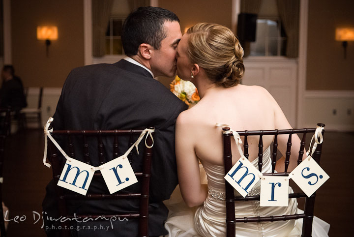 Bride and groom kissed at their sweetheart table. The Tidewater Inn Wedding, Easton Maryland, reception photo coverage of Kelsey and Jonnie by wedding photographers of Leo Dj Photography.