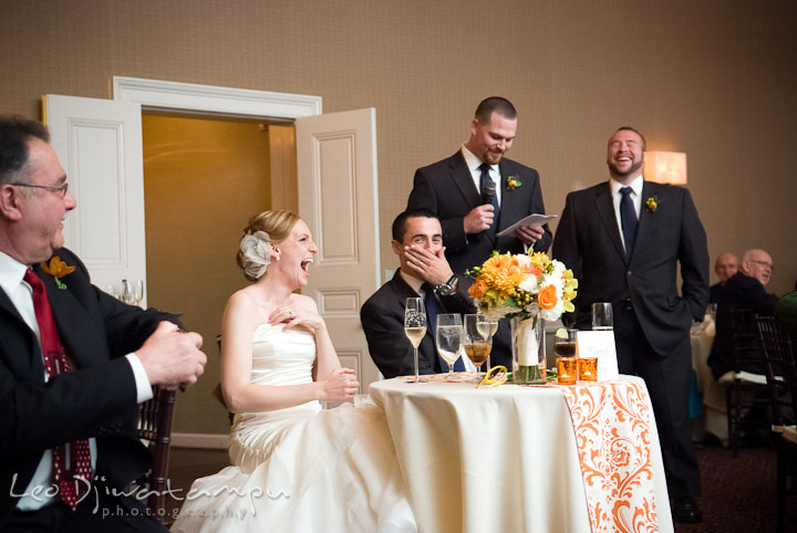 Bride and groom laughing while Best Man delivered speech. The Tidewater Inn Wedding, Easton Maryland, reception photo coverage of Kelsey and Jonnie by wedding photographers of Leo Dj Photography.