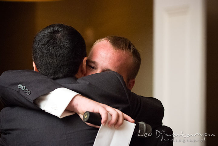 Best man hugged groom after speech. The Tidewater Inn Wedding, Easton Maryland, reception photo coverage of Kelsey and Jonnie by wedding photographers of Leo Dj Photography.