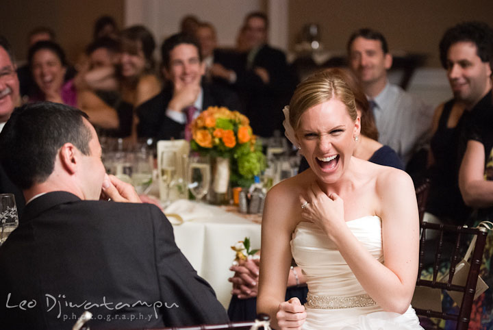 Bride laughing during maid of honor's speech. The Tidewater Inn Wedding, Easton Maryland, reception photo coverage of Kelsey and Jonnie by wedding photographers of Leo Dj Photography.
