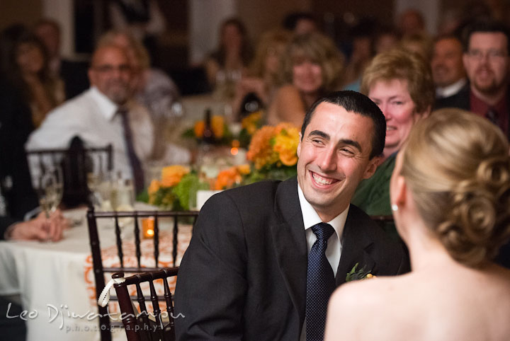 Groom laughing during matron of honor's speech. The Tidewater Inn Wedding, Easton Maryland, reception photo coverage of Kelsey and Jonnie by wedding photographers of Leo Dj Photography.