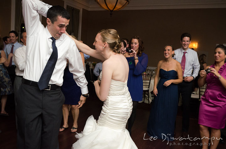 Groom trying to twirl bride. The Tidewater Inn Wedding, Easton Maryland, reception photo coverage of Kelsey and Jonnie by wedding photographers of Leo Dj Photography.