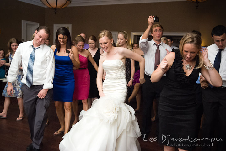 Bride, groom and guests dancing to Cupid Shuffle. The Tidewater Inn Wedding, Easton Maryland, reception photo coverage of Kelsey and Jonnie by wedding photographers of Leo Dj Photography.