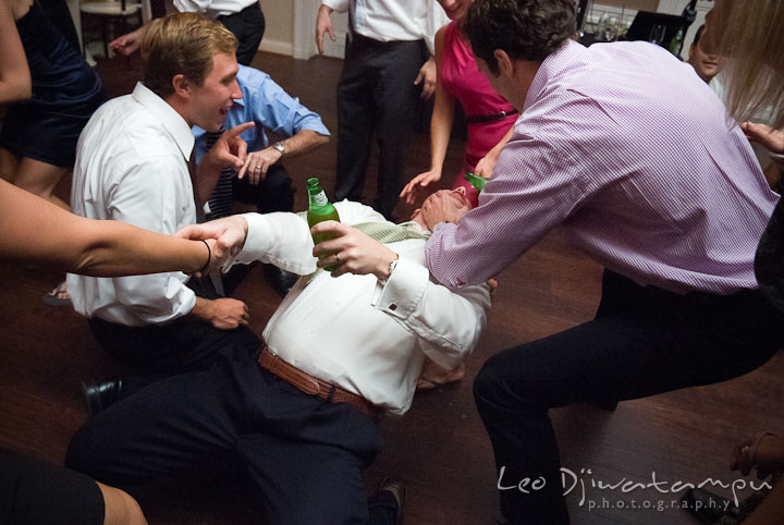 Guest pouring drink to another guest's mouth. The Tidewater Inn Wedding, Easton Maryland, reception photo coverage of Kelsey and Jonnie by wedding photographers of Leo Dj Photography.