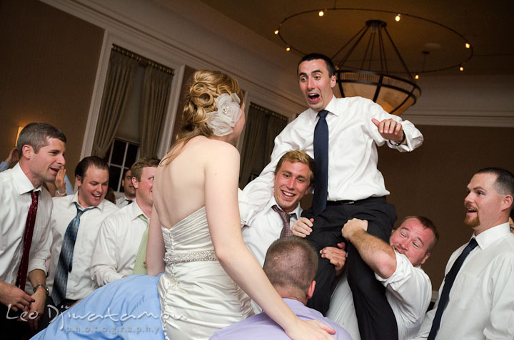 Bride and groom lifted up by guests. The Tidewater Inn Wedding, Easton Maryland, reception photo coverage of Kelsey and Jonnie by wedding photographers of Leo Dj Photography.