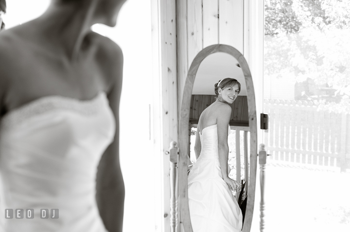 Bride checking out her dress on the mirror. Riverhouse Pavilion wedding photos at Easton, Eastern Shore, Maryland by photographers of Leo Dj Photography. http://leodjphoto.com